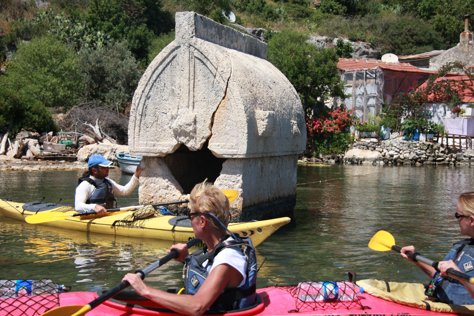 people kayaking around a king grave