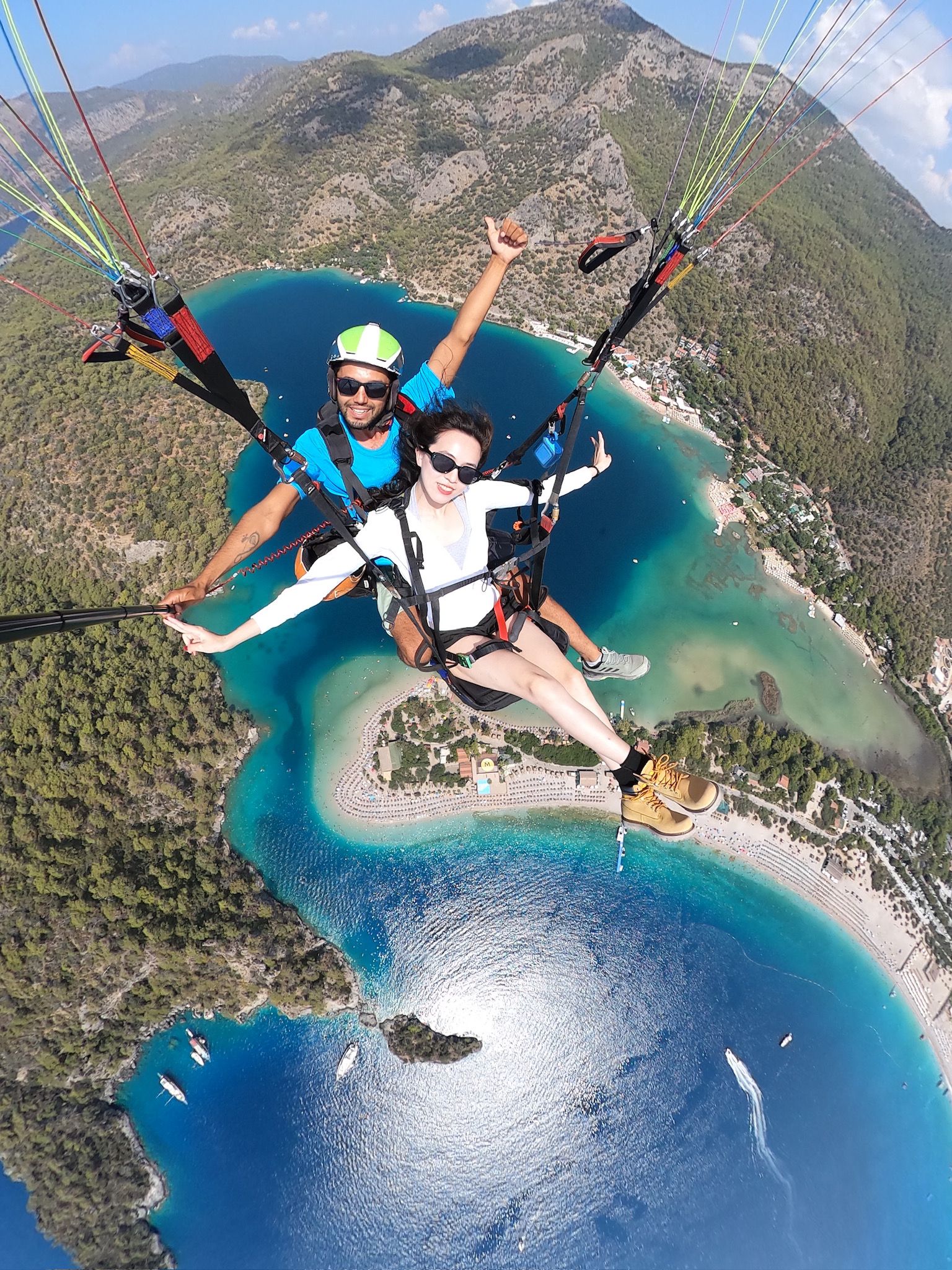 People paragliding on a blue sea